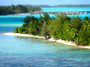 Four Seasons Resort in background and locals enjoying the water in foreground