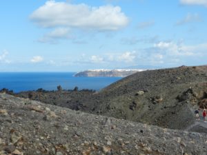 Santorini in the distance. What could be at first mistaken for snow at the top of Santorini is the village ofFinikia.